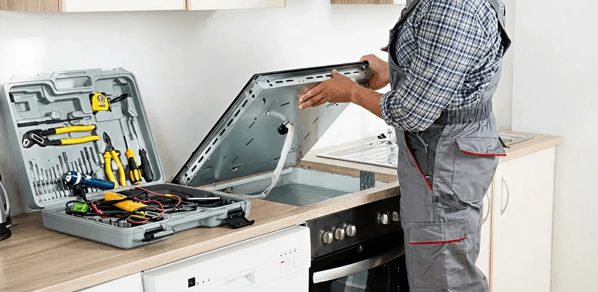 Handyman repairing a cooktop and checking wiring connections in Chula Vista, CA