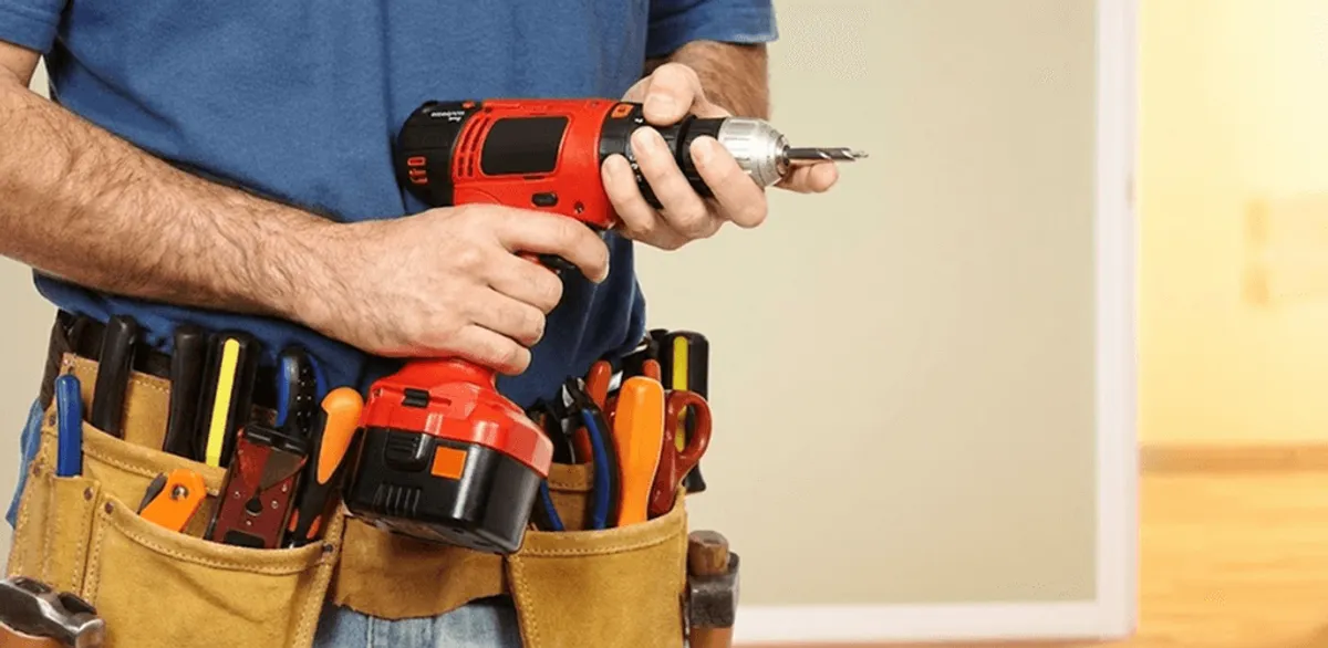 Handyman holding a power drill for home repairs and installations in Chula Vista, CA